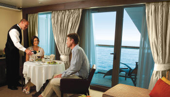 1548637861.6743_r536_Seabourn Encore Interior in suite dining white drapes.jpg